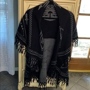 Like new sleeveless, open front poncho.